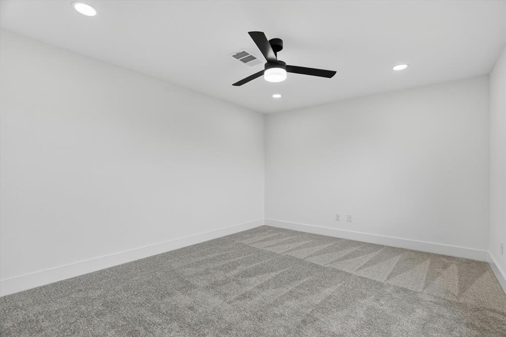 225 Kilkenny Road Poolville, TX 76487 - Photo 20 of 36 Spacious room featuring light gray carpeting with a subtle geometric pattern, recessed lighting, a contemporary ceiling fan with integrated light, white baseboards, and neutral wall tones