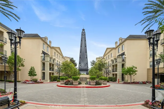 a view of a tall building next to a road