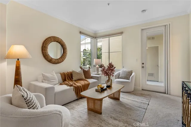 a living room with furniture a window and a lamp
