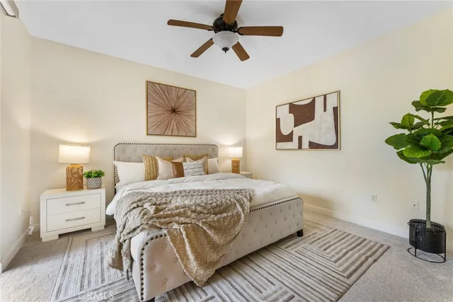 a bedroom with a bed and a potted plant