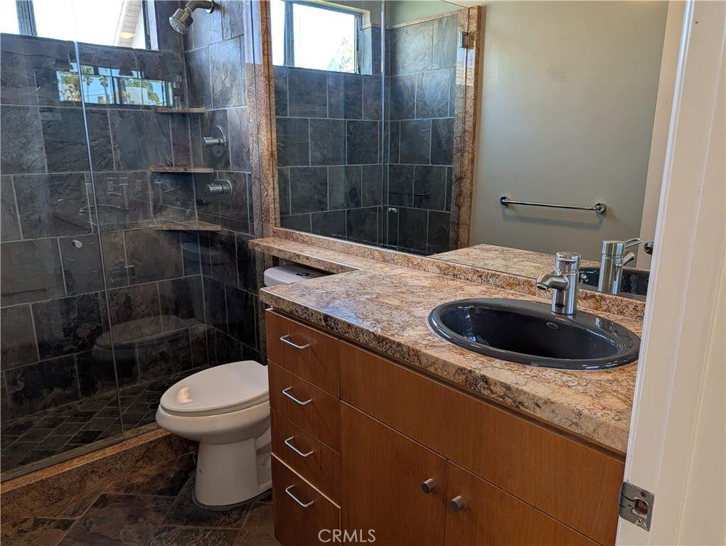 1451 3rd Street Manhattan Beach, CA 90266 - Photo 14 of 23 a bathroom with a granite countertop sink a toilet and shower