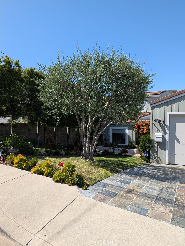 1451 3rd Street Manhattan Beach, CA 90266 - Photo 2 of 23 a front view of a house with a yard and garage