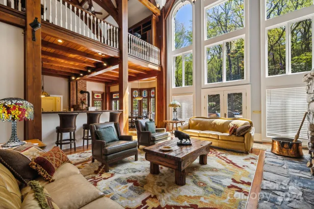 a view of a dining room with furniture large windows and wooden floor