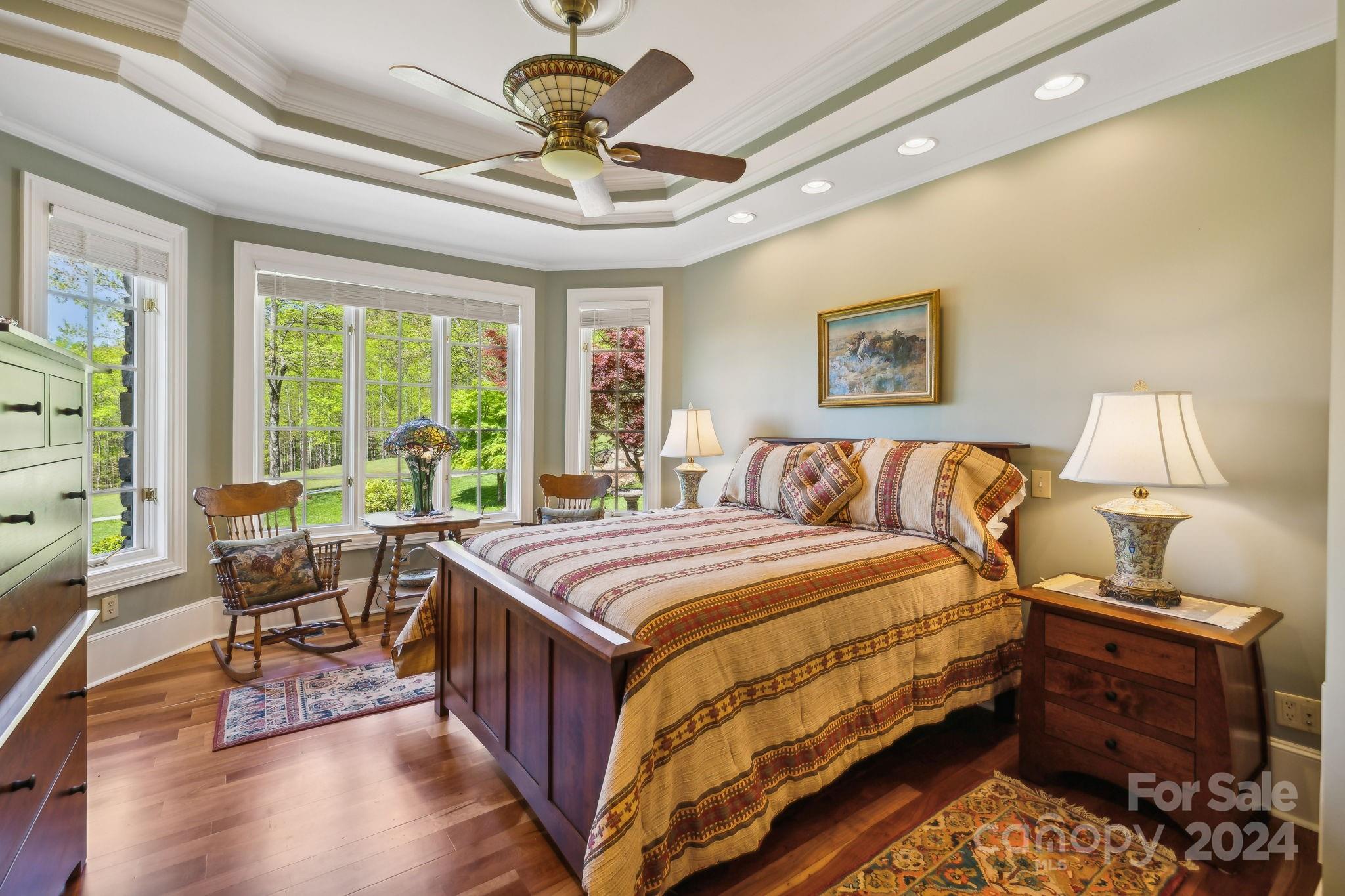 5712 Summit Road Purlear, NC 28665 - Photo 19 of 48 a bedroom with a bed and a chandelier