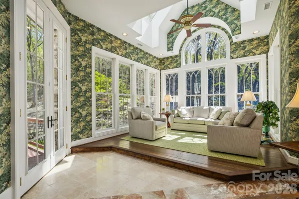 a living room with furniture and large windows