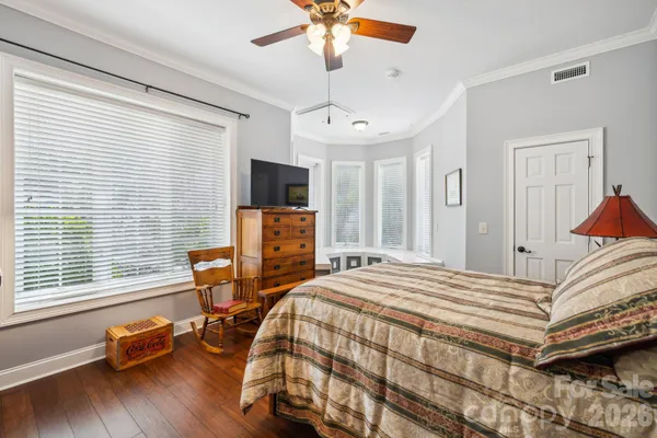 a bedroom with bed and a window