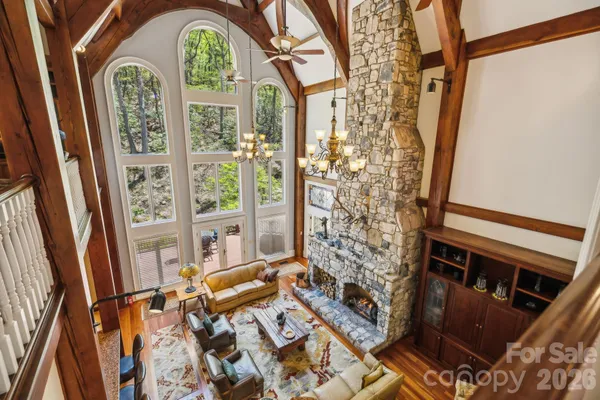 a view of an empty room with a fireplace and a large window