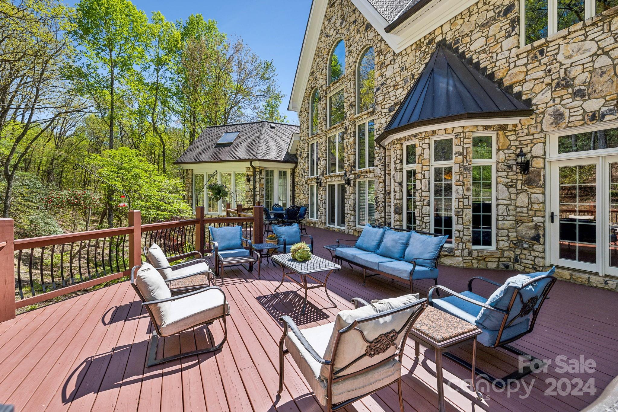 5712 Summit Road Purlear, NC 28665 - Photo 38 of 48 a view of a patio with couches table and chairs and potted plants