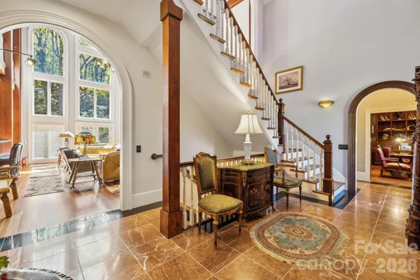 a living room with furniture a piano and wooden floor