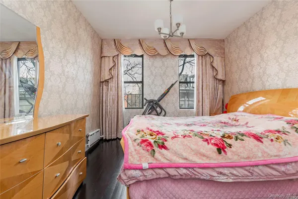 a bedroom with bed and wooden floor