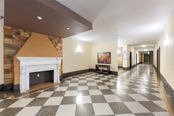 a view of a entryway with a rug a fireplace and wooden floor