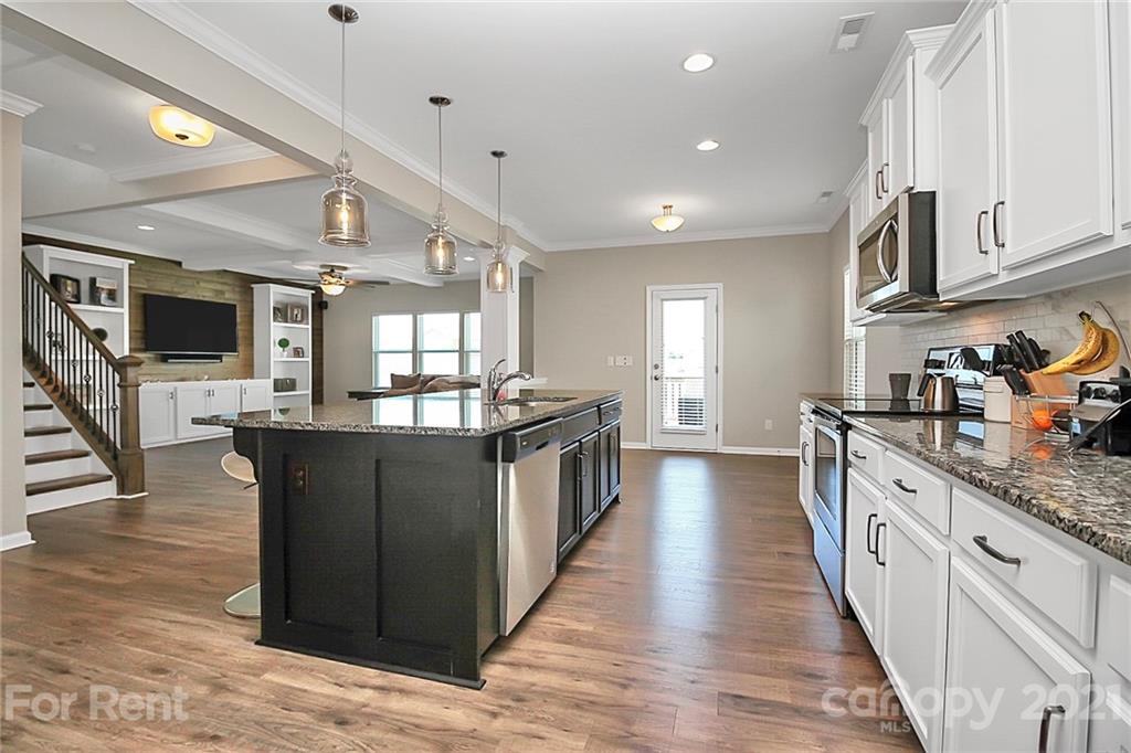 4925 Grace View Drive Pineville, NC 28134 - Photo 11 of 41 a kitchen with stainless steel appliances granite countertop a stove and a sink