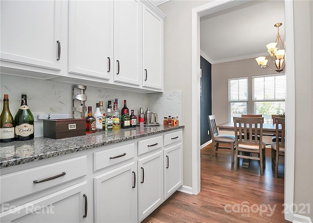 4925 Grace View Drive Pineville, NC 28134 - Photo 12 of 41 a kitchen with granite countertop white cabinets and dining table