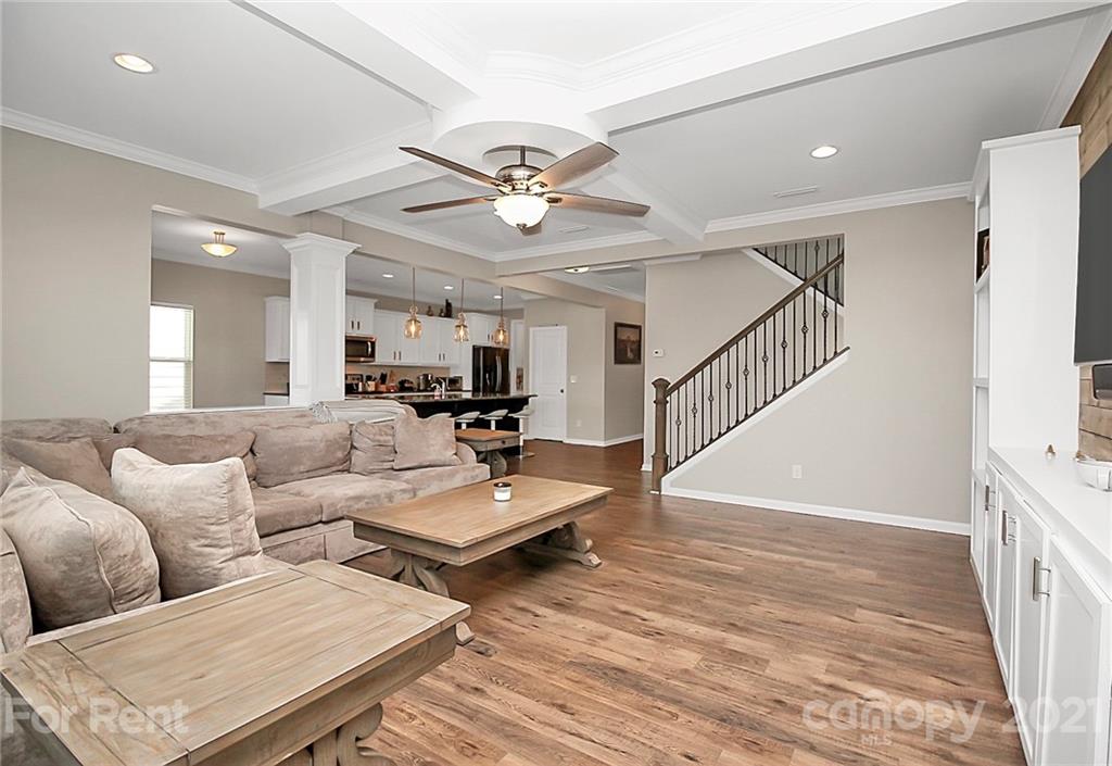4925 Grace View Drive Pineville, NC 28134 - Photo 17 of 41 a living room with lots of furniture and wooden floor