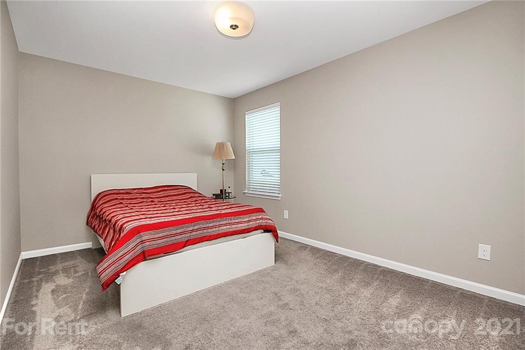 4925 Grace View Drive Pineville, NC 28134 - Photo 19 of 41 a bedroom with a bed and window