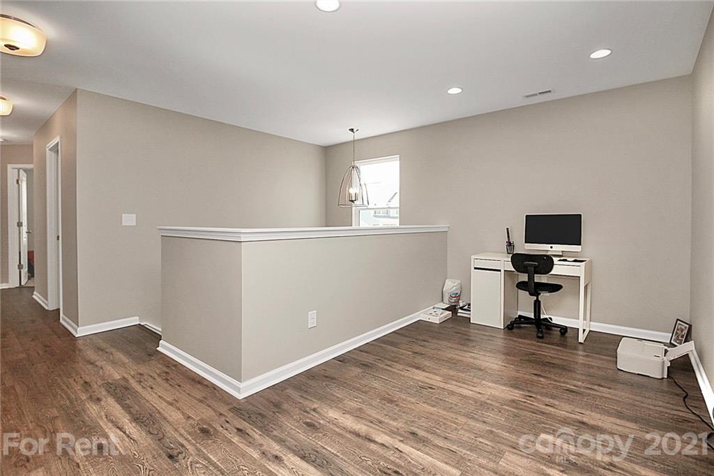 4925 Grace View Drive Pineville, NC 28134 - Photo 21 of 41 a view of a livingroom with wooden floor and a workspace