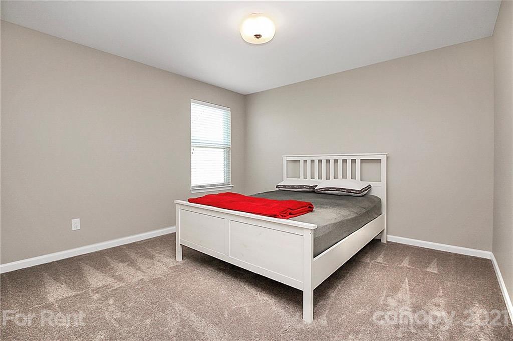 4925 Grace View Drive Pineville, NC 28134 - Photo 22 of 41 a living room with a bed and window