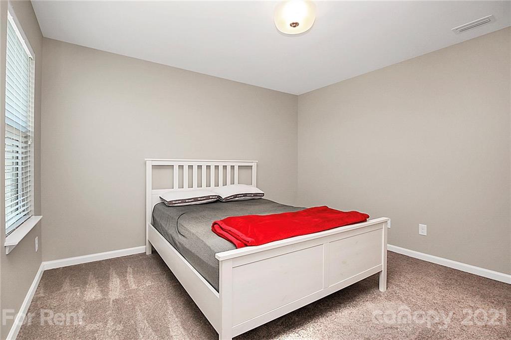 4925 Grace View Drive Pineville, NC 28134 - Photo 23 of 41 a bed sitting in a bedroom next to a window