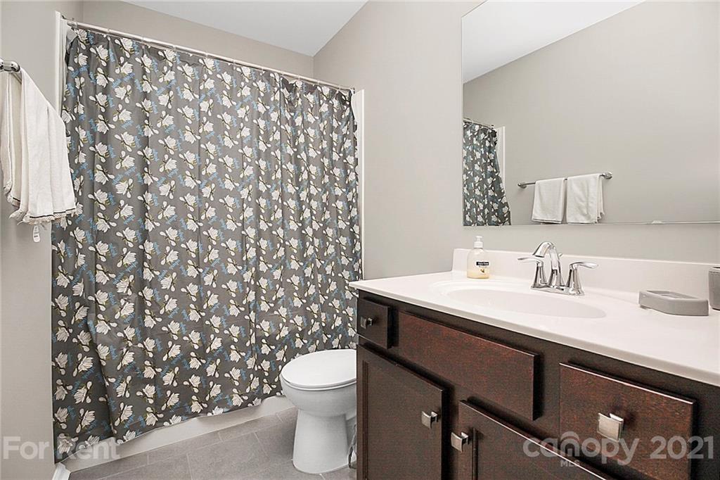 4925 Grace View Drive Pineville, NC 28134 - Photo 26 of 41 a bathroom with a sink toilet and a mirror