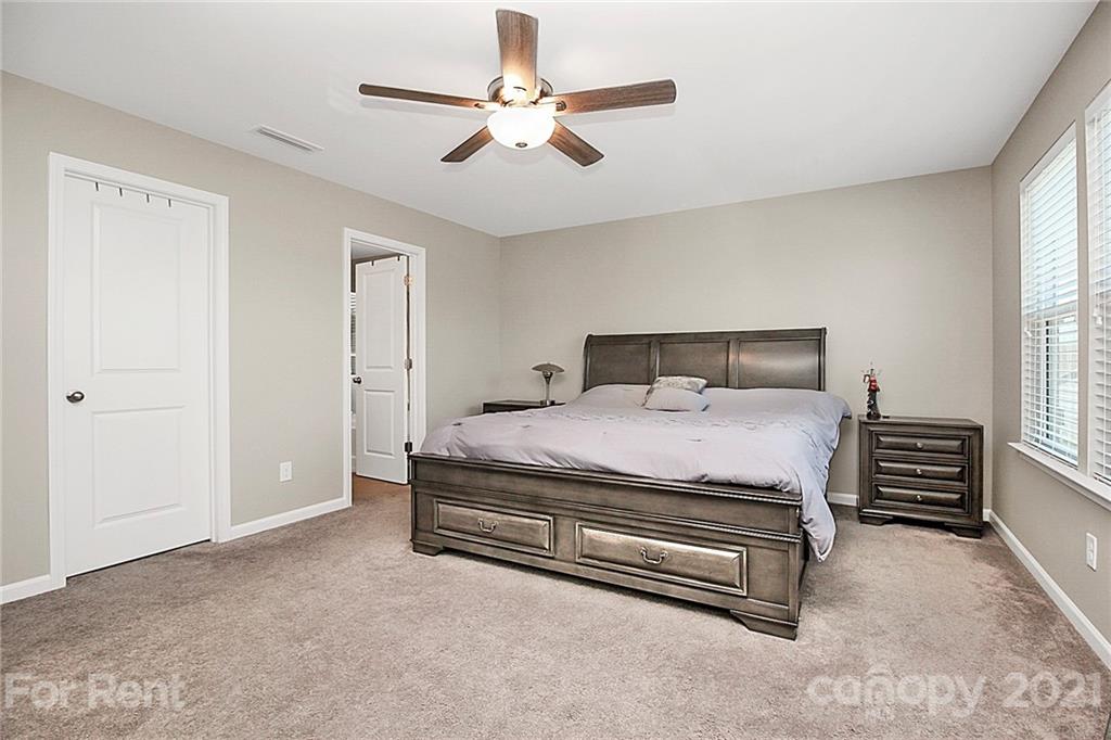 4925 Grace View Drive Pineville, NC 28134 - Photo 28 of 41 a bedroom with a bed dresser and a window