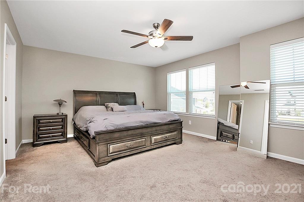 4925 Grace View Drive Pineville, NC 28134 - Photo 29 of 41 a bedroom with a bed and a large window with the outer view