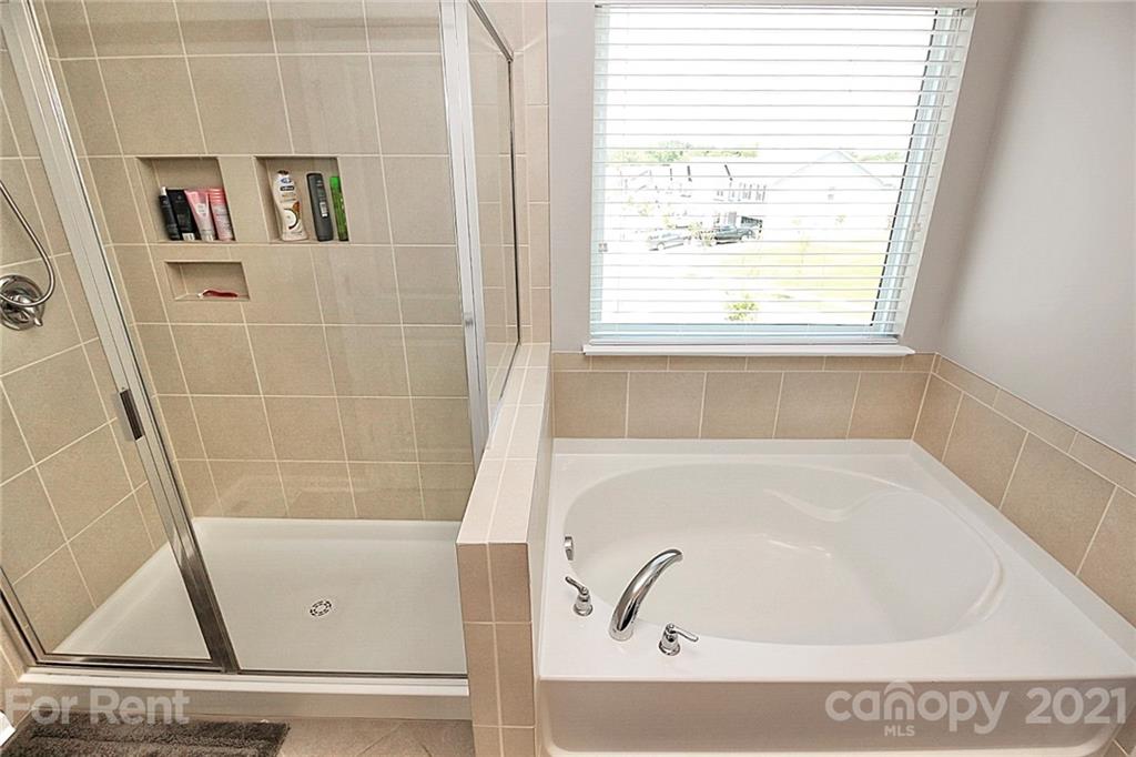 4925 Grace View Drive Pineville, NC 28134 - Photo 30 of 41 a bathroom with a bathtub and a window