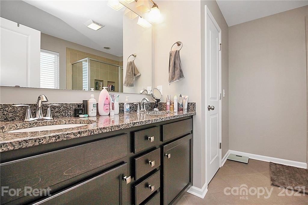 4925 Grace View Drive Pineville, NC 28134 - Photo 32 of 41 a bathroom with double sink and a mirror