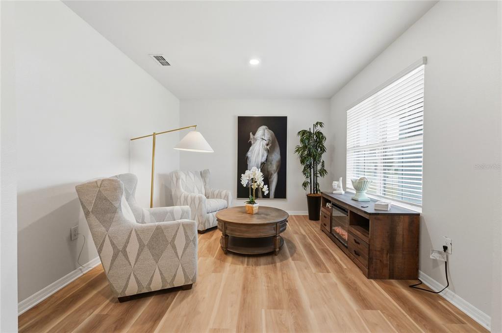 416 Corso Loop Winter Haven, FL 33884 - Photo 11 of 73 a living room with furniture and a large window