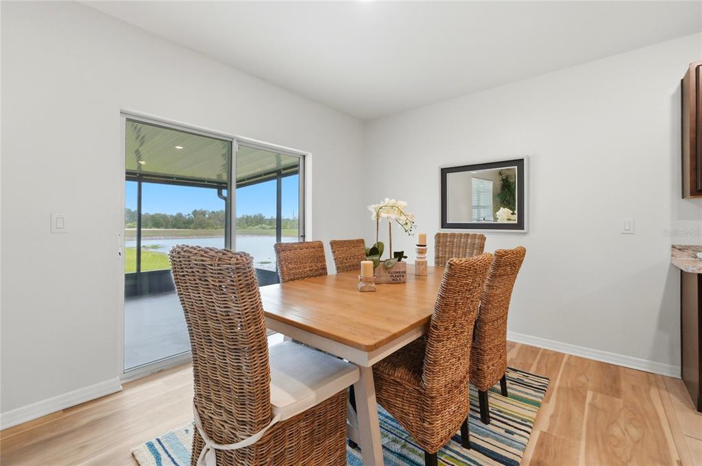 416 Corso Loop Winter Haven, FL 33884 - Photo 18 of 73 a view of a dining room with furniture a chandelier and wooden floor