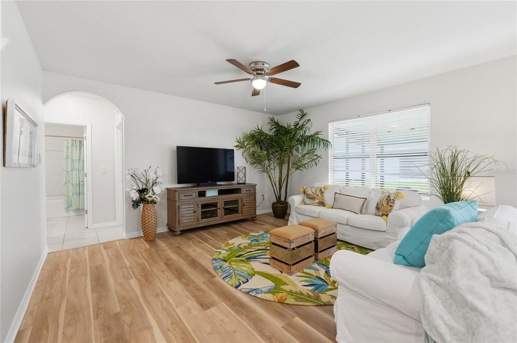 416 Corso Loop Winter Haven, FL 33884 - Photo 21 of 73 a living room with furniture a flat screen tv and a table