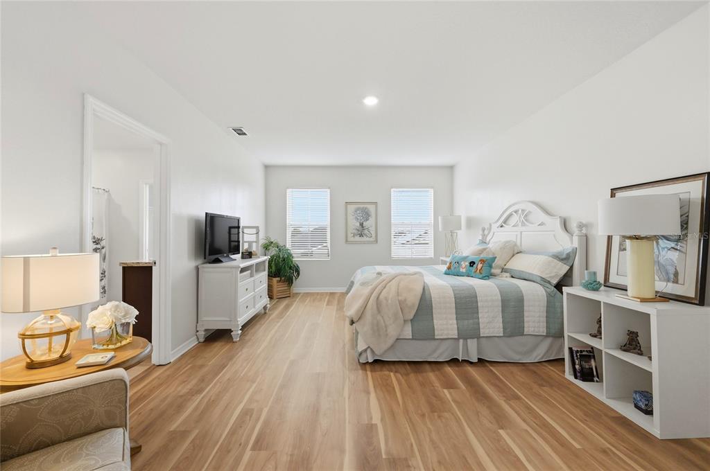 416 Corso Loop Winter Haven, FL 33884 - Photo 28 of 73 a spacious bedroom with a bed and a flat screen tv