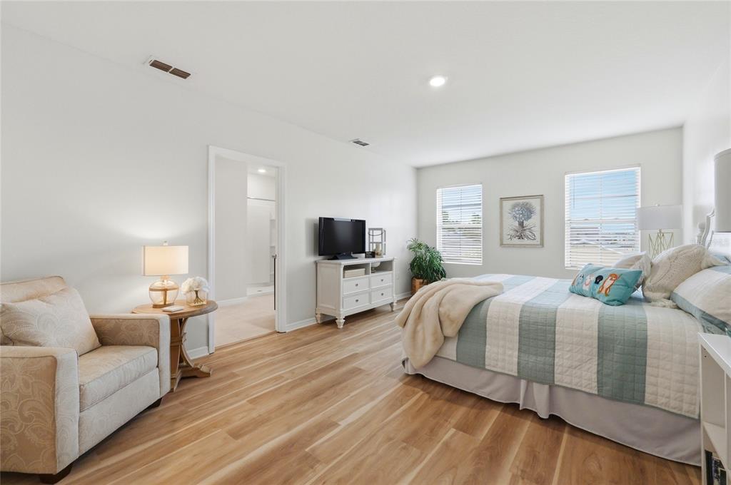 416 Corso Loop Winter Haven, FL 33884 - Photo 29 of 73 a spacious bedroom with a bed and a view of kitchen