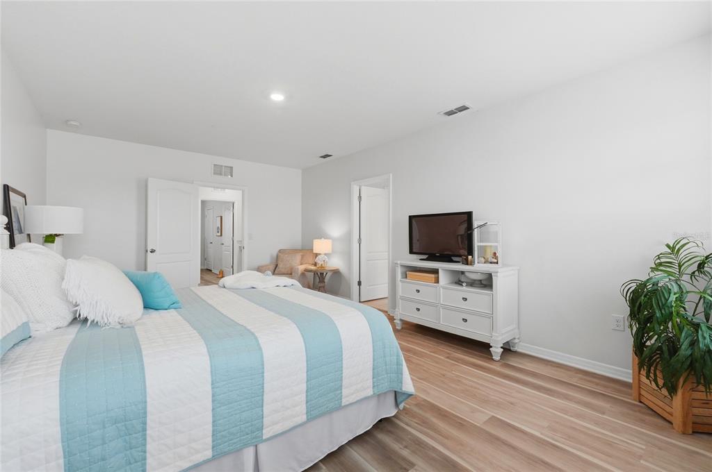 416 Corso Loop Winter Haven, FL 33884 - Photo 32 of 73 a bedroom with a bed and a flat screen tv