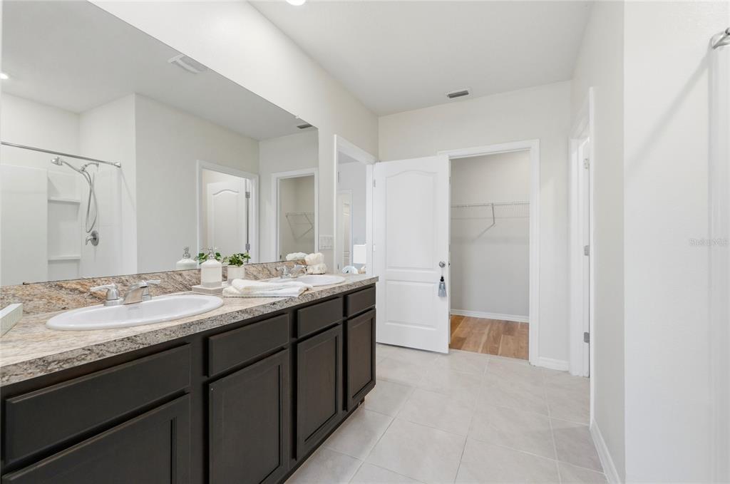 416 Corso Loop Winter Haven, FL 33884 - Photo 33 of 73 a bathroom with a granite countertop sink and a mirror
