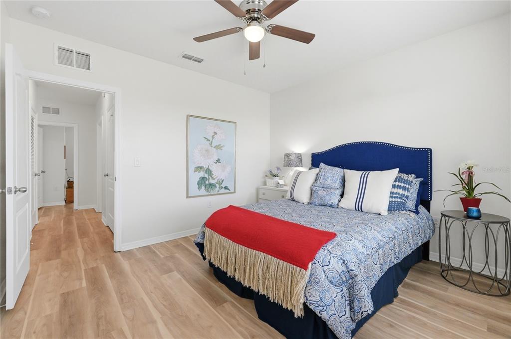 416 Corso Loop Winter Haven, FL 33884 - Photo 39 of 73 a bedroom with a bed and a chandelier