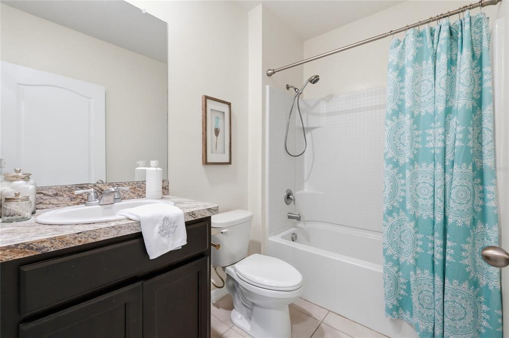 416 Corso Loop Winter Haven, FL 33884 - Photo 41 of 73 a bathroom with a granite countertop sink toilet and shower