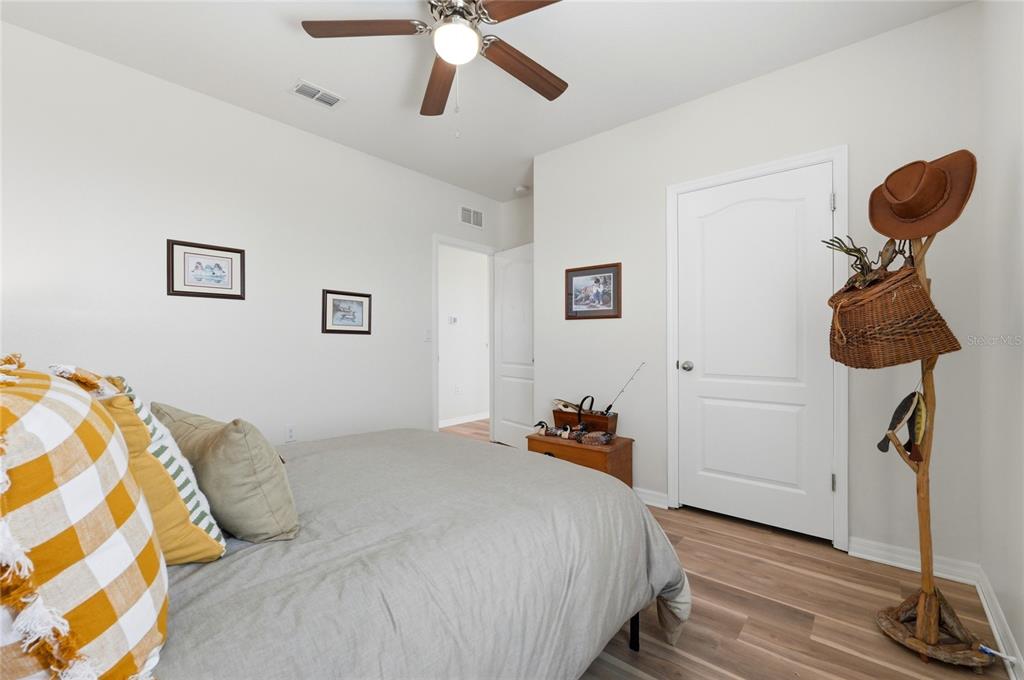 416 Corso Loop Winter Haven, FL 33884 - Photo 44 of 73 a bedroom with a bed and a chandelier
