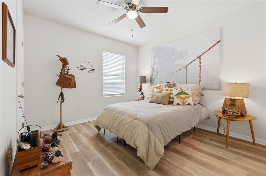 416 Corso Loop Winter Haven, FL 33884 - Photo 45 of 73 a bedroom with a bed and wooden floor