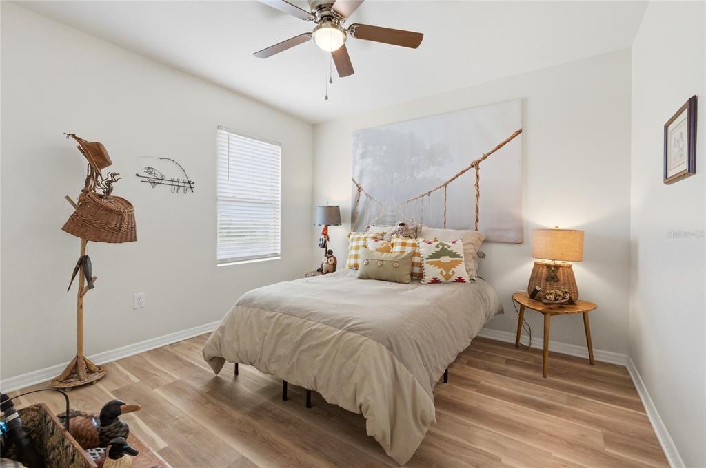 416 Corso Loop Winter Haven, FL 33884 - Photo 46 of 73 a bedroom with a bed and a chandelier