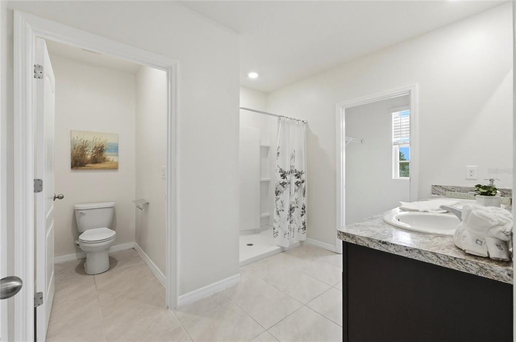 416 Corso Loop Winter Haven, FL 33884 - Photo 47 of 73 a bathroom with a sink toilet and shower