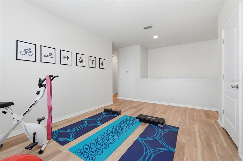 416 Corso Loop Winter Haven, FL 33884 - Photo 49 of 73 a bedroom with furniture and a wooden floor