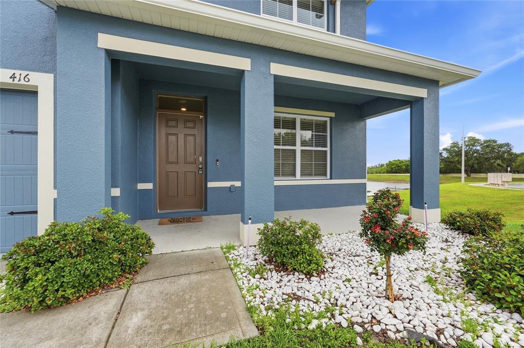 416 Corso Loop Winter Haven, FL 33884 - Photo 6 of 73 a front view of a house with garden