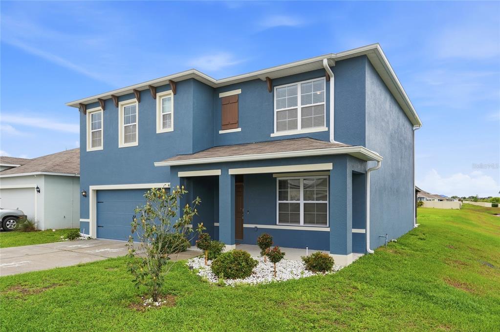416 Corso Loop Winter Haven, FL 33884 - Photo 70 of 73 a front view of a house with a yard and porch