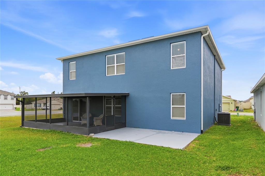 416 Corso Loop Winter Haven, FL 33884 - Photo 72 of 73 a front view of a house with garden