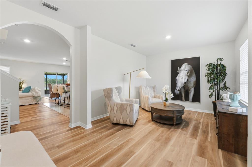 416 Corso Loop Winter Haven, FL 33884 - Photo 9 of 73 a living room with furniture and a wooden floor