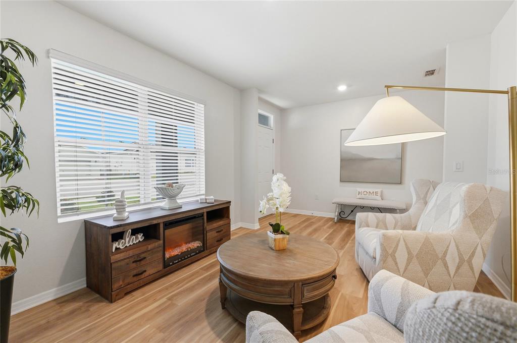 416 Corso Loop Winter Haven, FL 33884 - Photo 10 of 73 a living room with furniture and a wooden floor