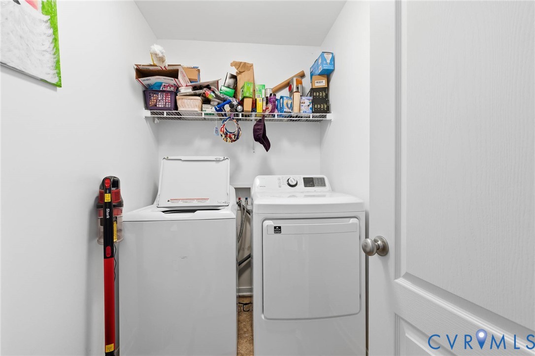 15900 Nobles Road Disputanta, VA 23842 - Photo 22 of 36 a utility room with dryer washer and a view of living room