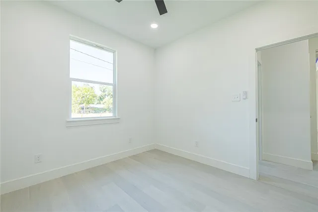 a bathroom with a granite countertop sink mirror vanity and toilet