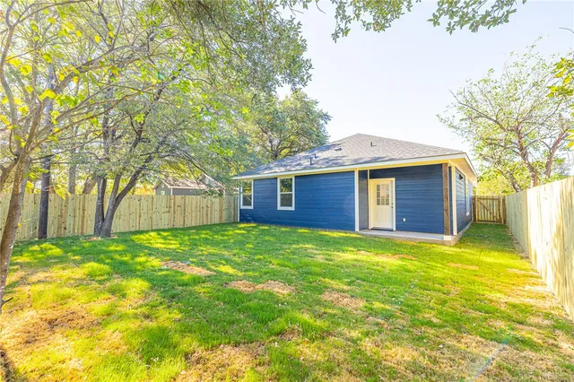 a view of a backyard with large trees