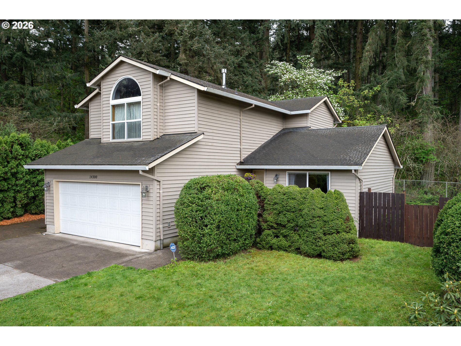14300 Southeast Center Street Portland, OR 97236 - Photo 1 of 48 a front view of a house with a garden